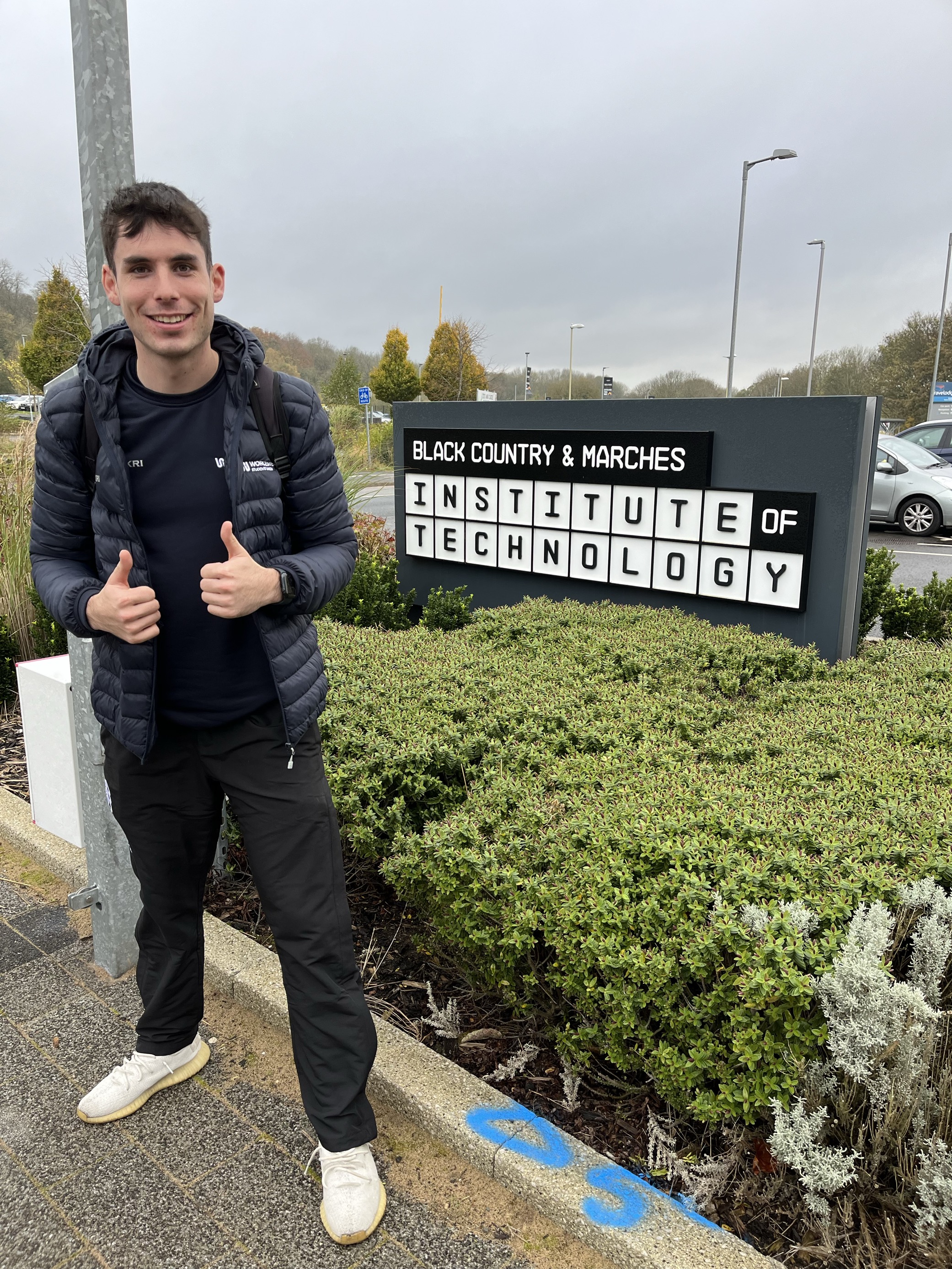A photograph of SU Vice President Student Activites outside the Dudley Institute of Technology building 
